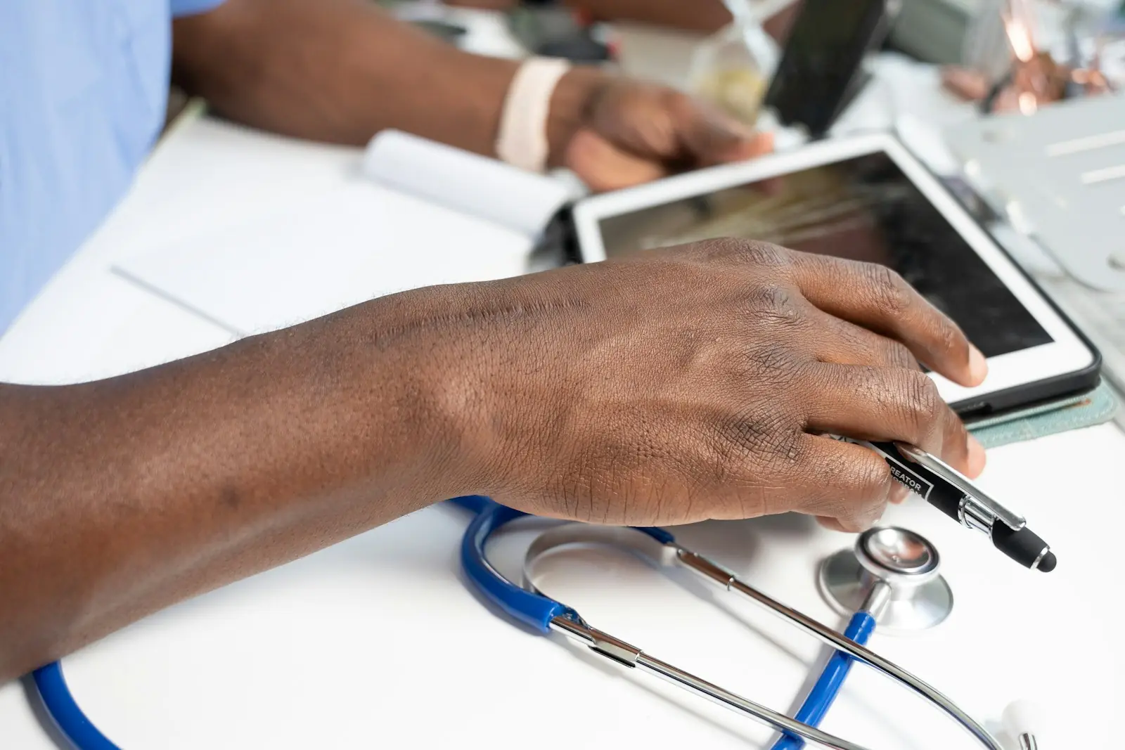 A clinician reviewing notes on a tablet